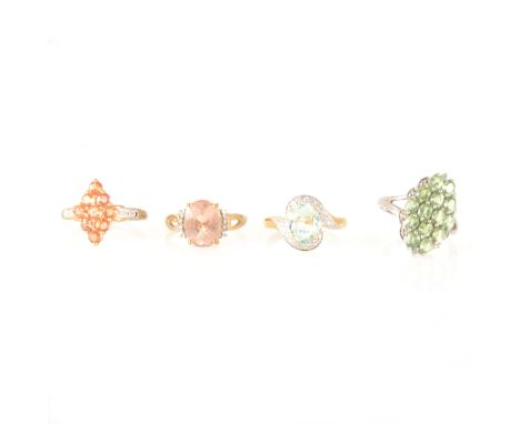 A Paraiba tourmaline and diamond ring, the oval mixed cut tourmaline 9.1mm x 7mm four claw set in an 18 carat yellow gold mou