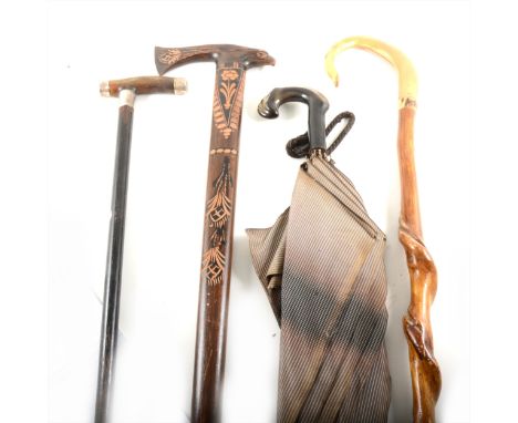 An ebonised walking stick, horn handle and plated mounts, other walking sticks and an umbrella. (Qty: 8)