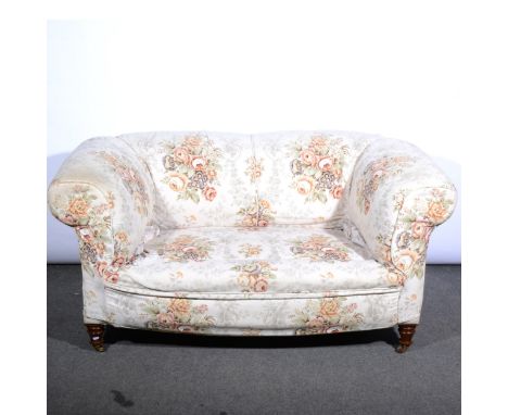 A small Victorian two-seater Chesterfield sofa, reupholstered in cotton print, turned and ringed legs, width 162cm.