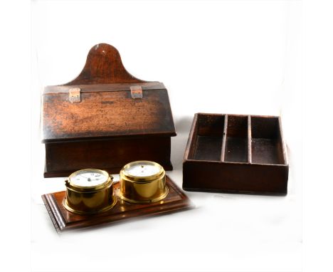 An old oak candle box, with a slope front, width 41cm; cutlery tray; and a ship's type clock and barometer set, by Wempe. (3)