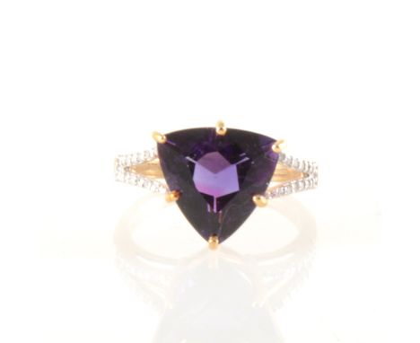An amethyst and diamond ring, the triangular mixed cut amethyst approximately 11.7cm, with two shoulders parting at the front