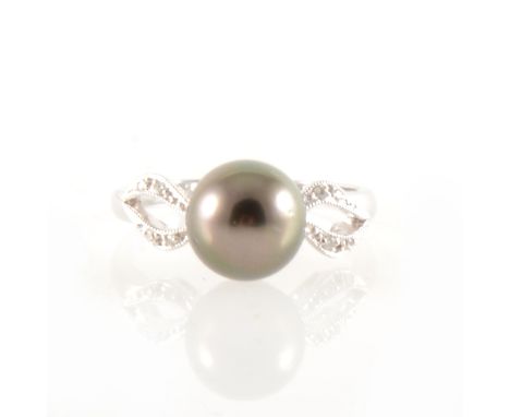 A Tahitian pearl and diamond ring, the 9mm pearl peg set between two shoulders, each shoulder parting at the front with four 