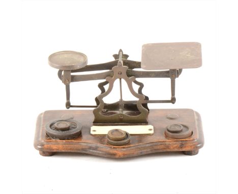 A set of postal balance scales, stained wood platform, width 20cm.