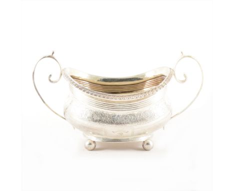 A George III silver sugar basin, maker's mark rubbed, London 1814, shaped overall form, bright cut engraved decoration, monog