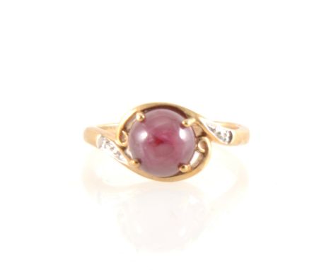 A cabochon cut star stone ring, the round cabochon cut red stone 8.2mm diameter, four claw set in a 9 carat yellow gold mount