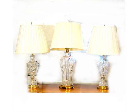 Pair of cut-glass table lamps, urn-shape, with shades, and a similar large glass table lamp. (3)