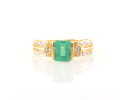 An emerald and diamond ring, the rectangular step cut emerald 7.1mm, claw set between two shoulders, each shoulder split into