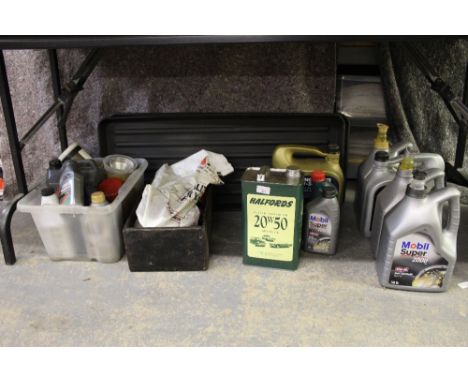 Vintage grease gun and a quantity of opened bottles of engine oil, grease, etc together with two plastic drip trays