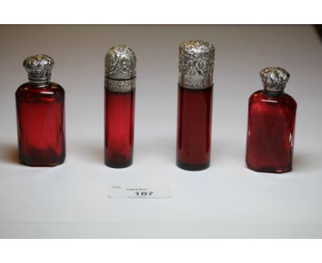Two Victorian white metal (thought silver) topped ruby glass cylindrical scent bottles, both with internal stoppers and two d