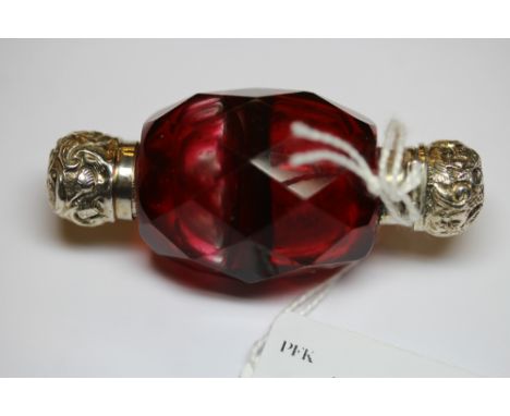 Victorian white metal (thought silver) mounted double ended ovoid ruby glass scent bottle, with faceted body (slight wear)