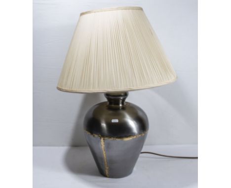 A silvered metal table lamp with shade, base 37cm tall