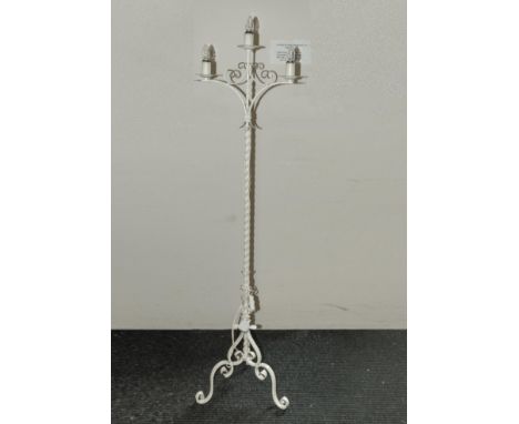 A wrought iron standard lamp