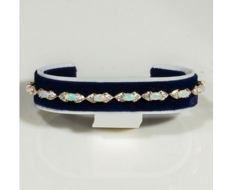 A 9ct yellow gold opal and diamond bracelet