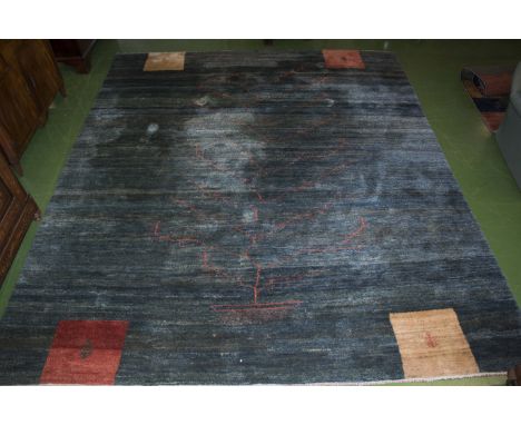 A large blue ground wool carpet with tree design, originally from Harrods of London, size 3.5m x 2.96m