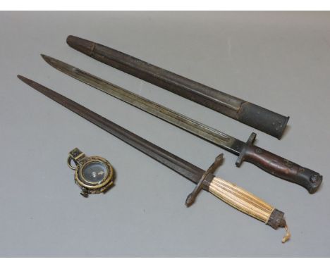An old bayonet and scabbard, a bone handled dagger, and a military compass