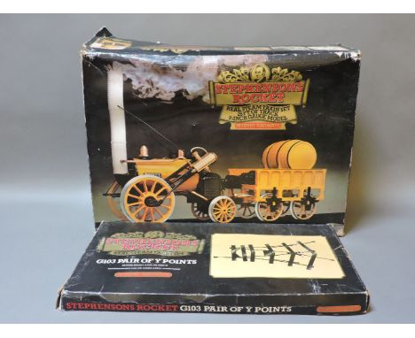 A Hornby live steam model of Stephenson's Rocket, boxed, with train