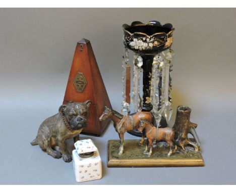 A metronome, a Victorian black glass and enamelled table lustre, two table lighters, one Austrian cold painted example modell