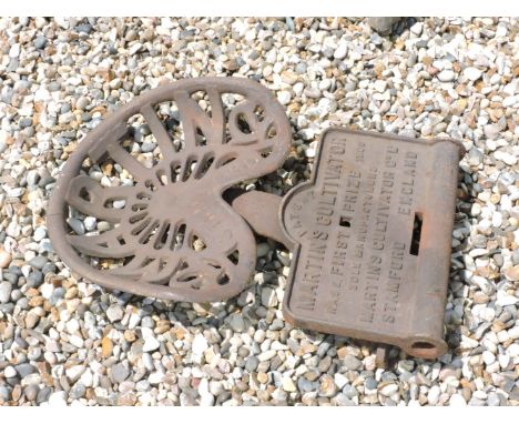 An iron Martin Stamford tractor seat, and a cast metal sign