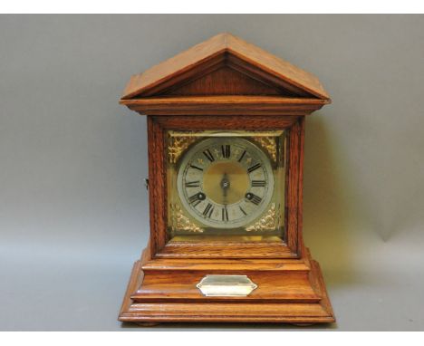 An oak mantel clock with architectural case, striking the hours on a gong, 33cm high