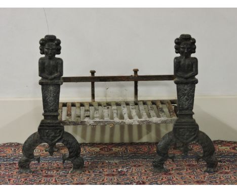 A pair of cast iron figural fire dogs, and fire grate, 58cm high