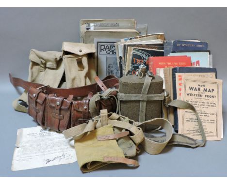 WWII memorabilia, including an ammunition belt, a water bottle, books and magazines