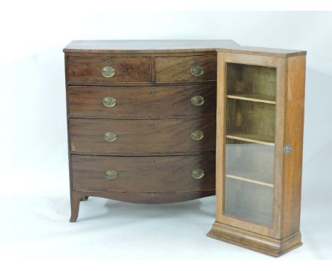 A Regency mahogany bow front chest of drawers, and a lined oak glazed cabinet