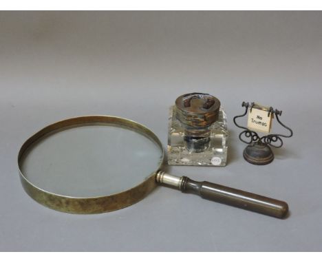 A large desk magnifying glass, 18.5cm diameter, an inkwell with agate horseshoe, and a trump marker
