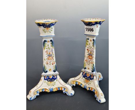 A PAIR OF QUIMPER FLORAL CANDLESTICKS RAISED ON THREE FEET.   H 14cms.