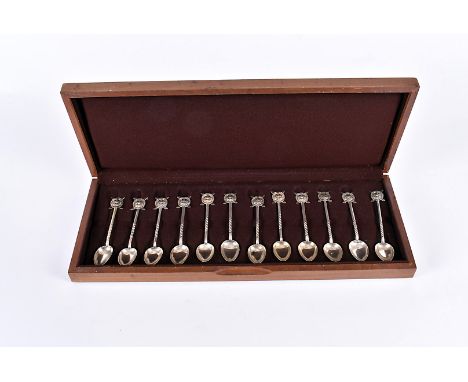 A cased set of 12 Chinese silver spoons, each having Shanghai Scottish emblem terminals, marked to the back of spoon, circa 1