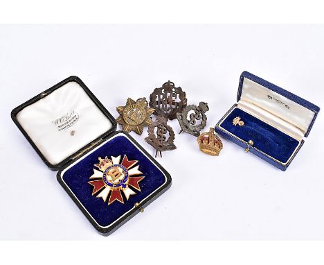 A Primrose League gilt and enamel pin badge, the central P on a flower, surrounded by motto, with crowned red and white ename