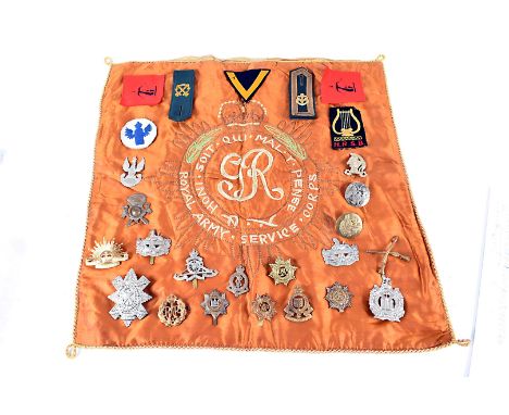 An assortment of metal cap and cloth badges, Royal Artillery Volunteers, RAF, RASC, RAMC, The Devonshire Regt and more, toget