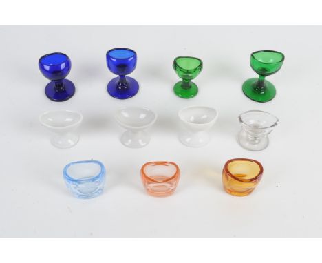 Eyebaths, large collection, mostly blue, green, white or clear moulded glass (apx. 100), with ground undersides or pontil rem