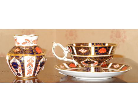 A Royal Crown Derby 1128 pattern pedestal teacup and saucer, printed marks;  a similar lobed ovoid vase, 7.5cm high, printed 