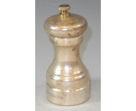 A silver pepper grinder of traditional slender waisted cylindrical form, 10cm high 