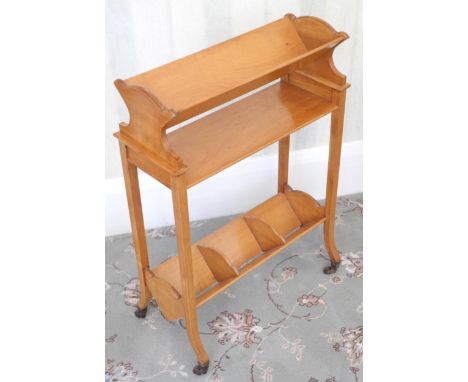 An early 20th century  Cowtan &amp; Sons book trough, splayed legs, casters, 74cm high, 52cm wide, with label, Cowtan &amp; S