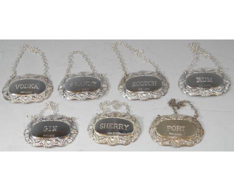 A set of 7 silver decanter or bottle tags for Sherry, Port, Rum, Gin, Scotch, Vodka and Brandy, various makers, modern 