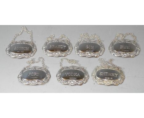 A set of 7 silver decanter or bottle tags for Sherry, Port, Rum, Gin, Scotch, Vodka and Brandy, various makers, modern 