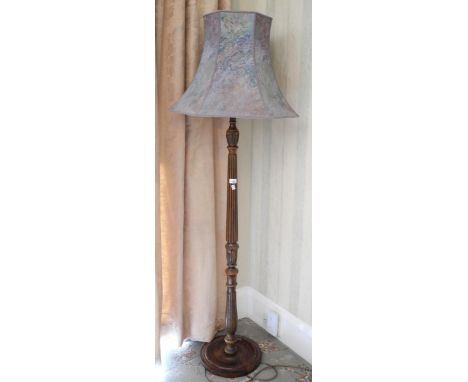 An early 20th century oak standard lamp, fluted, marbled blue shade 