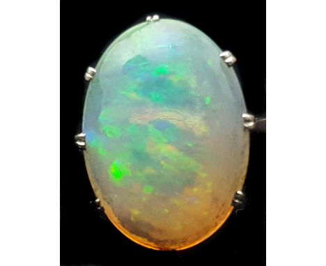 A 1920's harlequin opal single stone ring, the oval shaped opal with a good and even play of colour, claw set in an 18ct whit