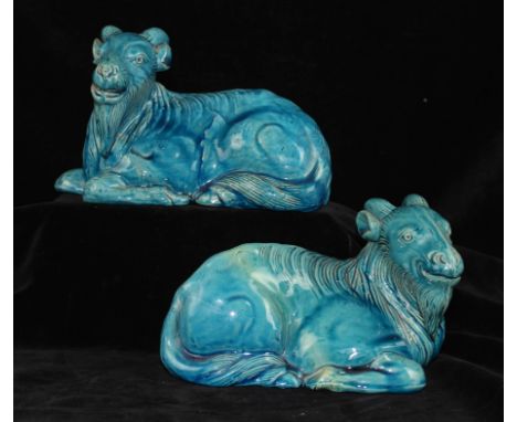 A pair of Chinese porcelain Kangxi style figures of recumbent rams, glazed in turquoise, 21cm max (2)  ** For a similar pair 