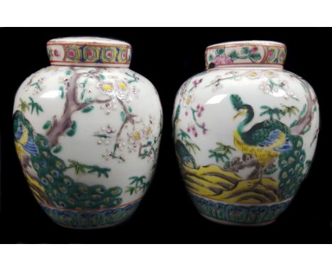 A pair of Chinese porcelain style pot pourri jars and covers with internal covers, decorated in famille verte enamels with cr