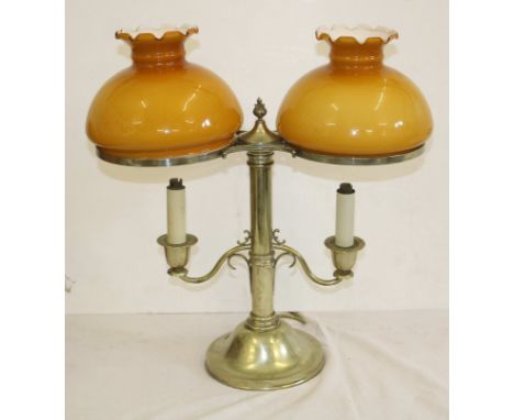 A silver plated two light table candelabra, the central stem supporting two s scroll sconces and arms with flame finial, abov
