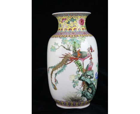 A Chinese porcelain vase in Famille rose colours with a pair of Phoenix birds atop rock work, beneath a band of scrolling fol