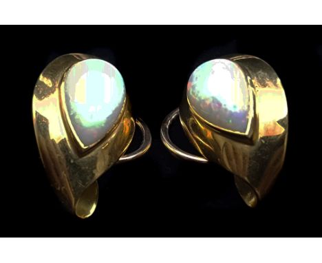 A pair of 1950's opal and yellow gold ear clips, of leaf shape, each set to the centre with a single pear shaped collet set o