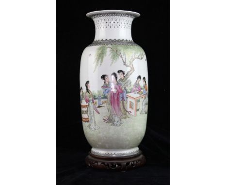 a Chinese porcelain vase of baluster form painted with female figurines in a garden setting .  Within black banding to neck a