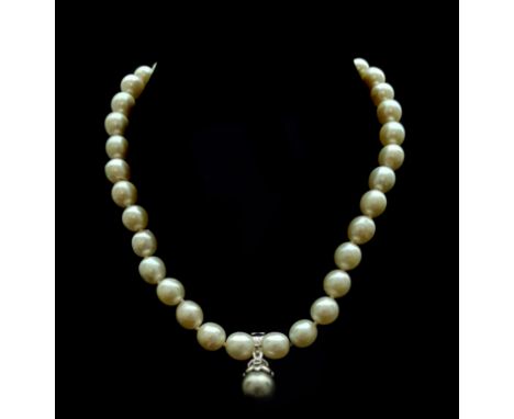 A slightly graduated row of thirty five, 9 - 10 mm untested pearls and/or cultured pearls to an antique nine stone diamond cl