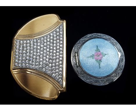 A vintage 1950's American paste and gilt metal compact; and a white metal compact with enamel style cover (2)