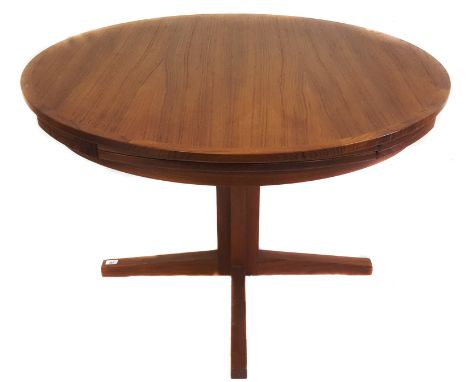 A Dyrlund teak Lotus or Flip-Flap dining table, 1970s, the round top lifts to reveal four expandable leaves supported by a X 