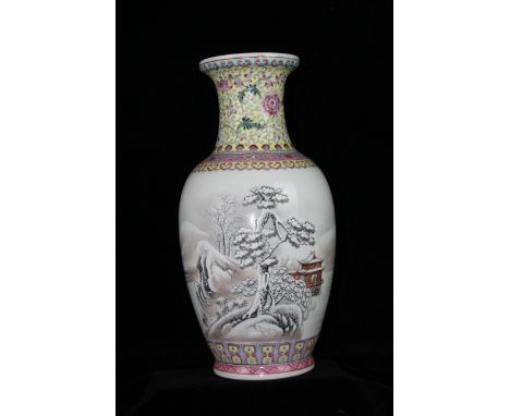 A Chinese porcelain vase decorated in famille rose colours with a snow scene of trees rocks and a pagoda beneath a neck decor