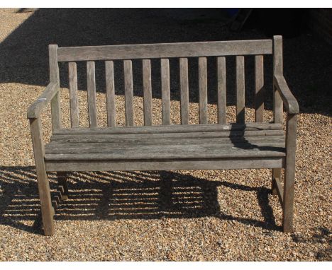 A traditional slatted wooden two seat garden bench, 123 cm wide x 85 cm high x 60 cm deep